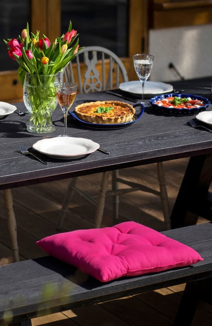 outdoor dining table with pink cushion